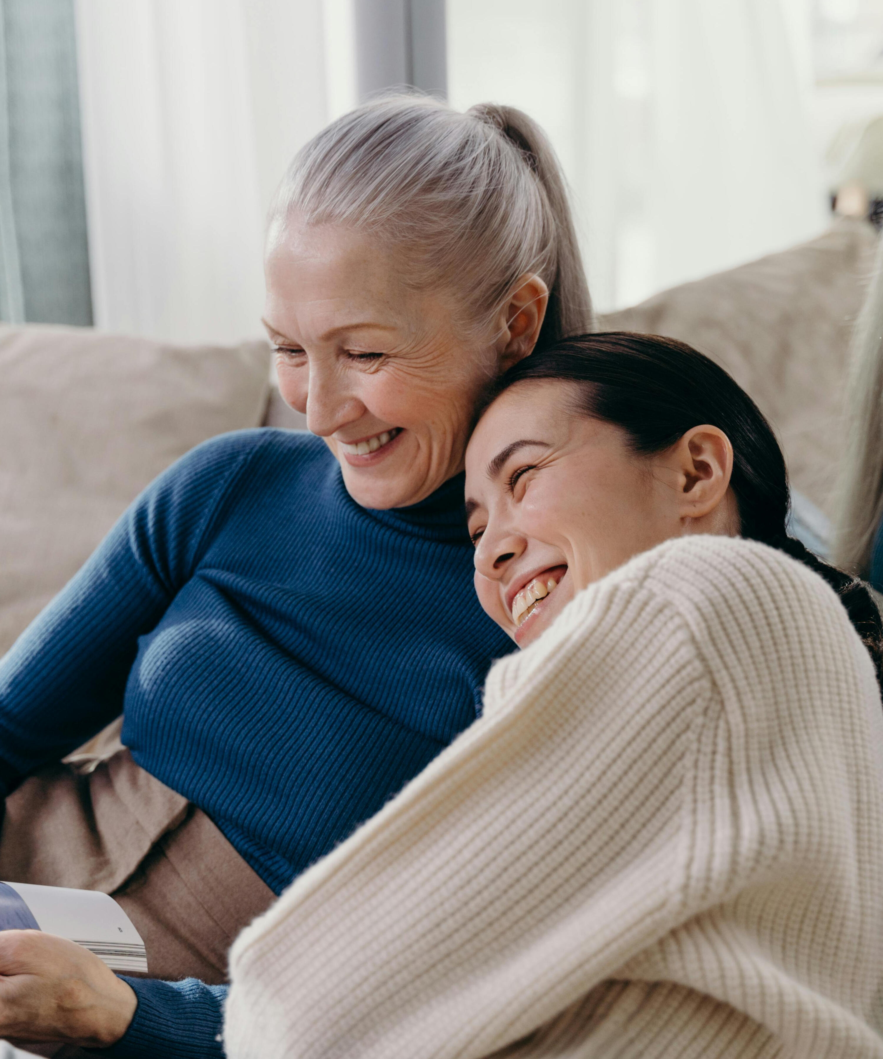 Middle-aged daughter comforting her distressed elderly mother, symbolising the emotional and practical challenges of caregiving while juggling family and work